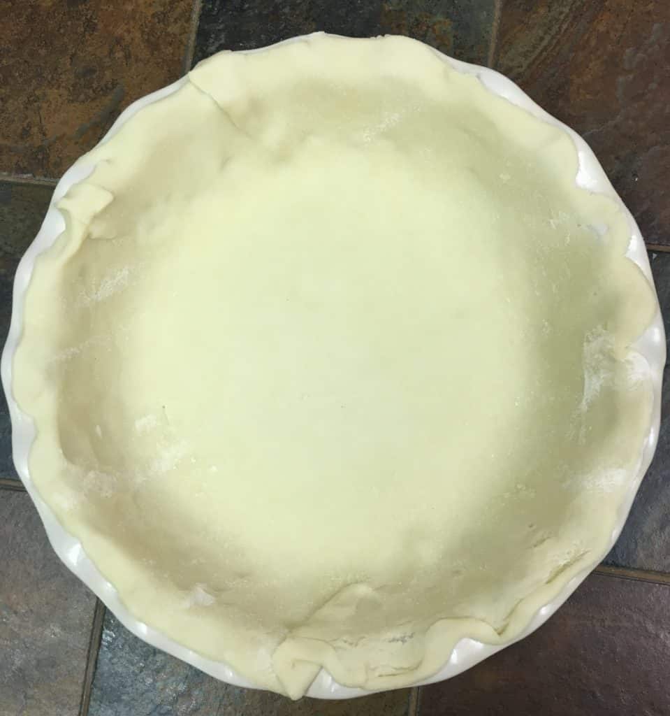 Pie crust rolled out in a deep dish pie pan.