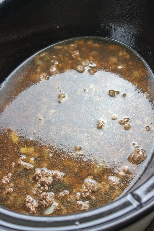 Picture of beef and beef broth in a slow cooker