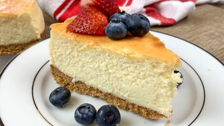 Cheesecake on a plate with strawberries and blueberries