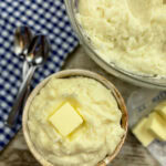 Mashed potatoes in a bowl with butter.