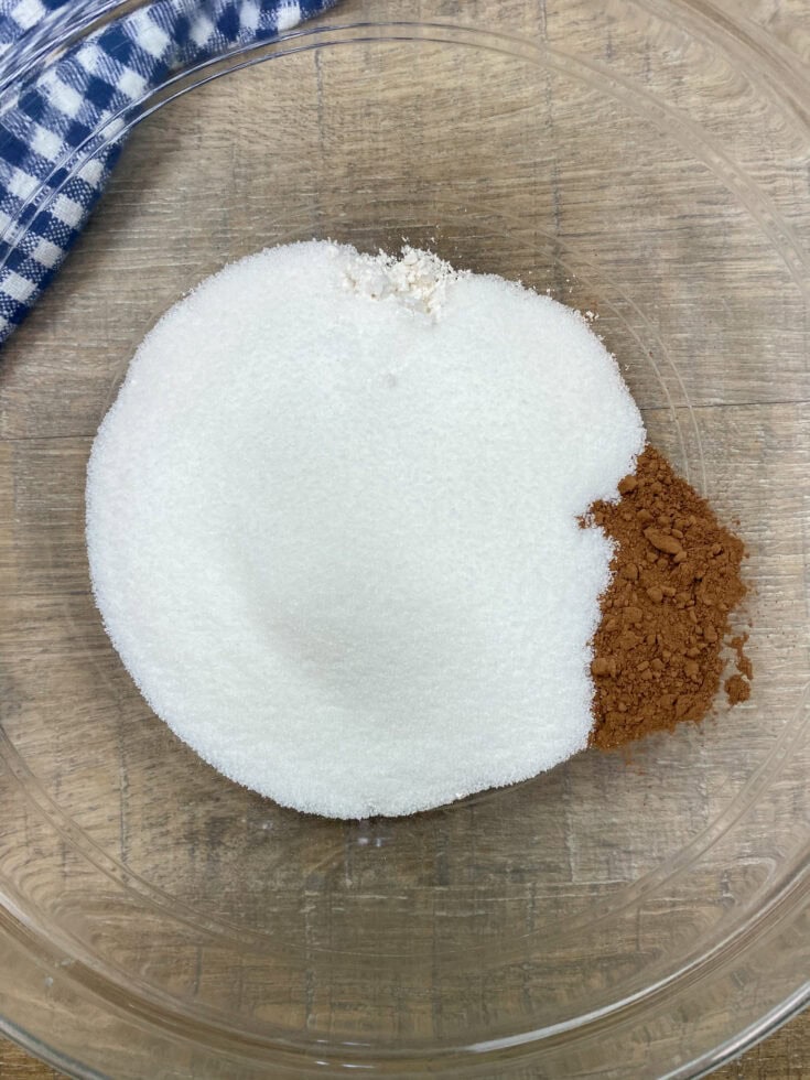 Cocoa, flour, and sugar in a glass bowl. 