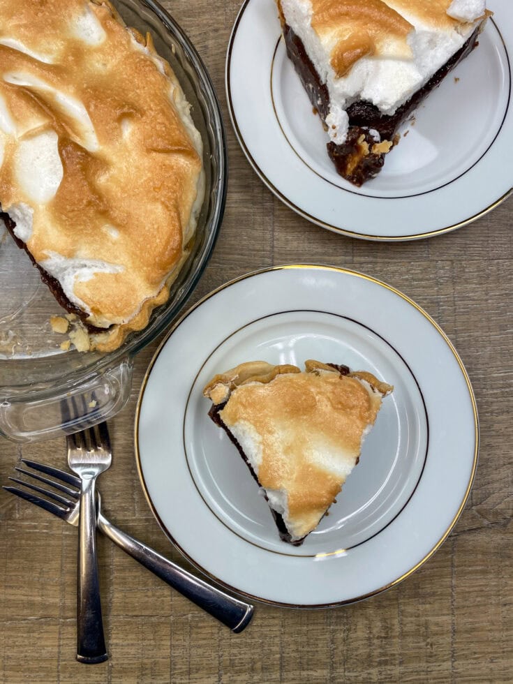 Two slices of chocolate pie on white plates. 