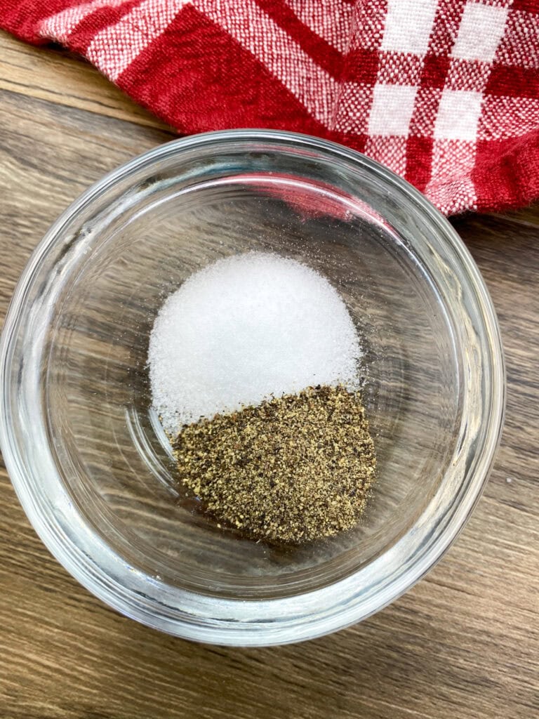 Salt and pepper in a small glass bowl. 