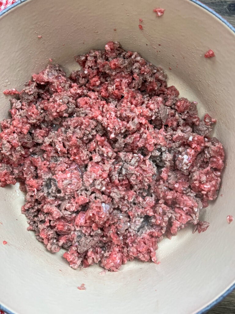 Cooking ground beef in a large saucepan.