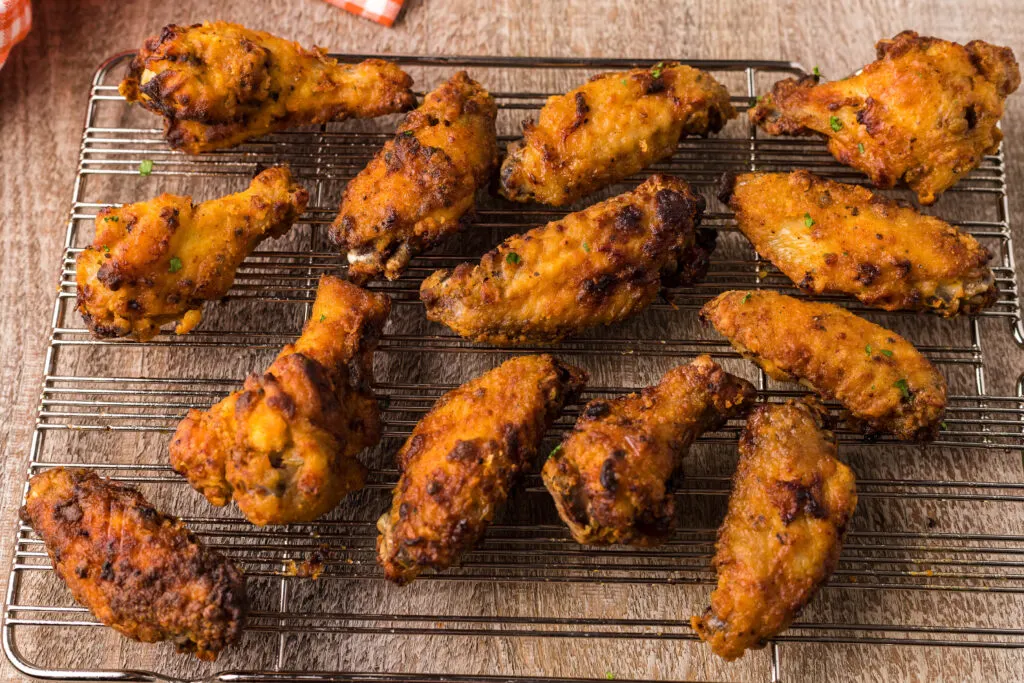 Crispy Air Fryer Chicken Wings Recipe - Shown on two racks in the air fryer  oven