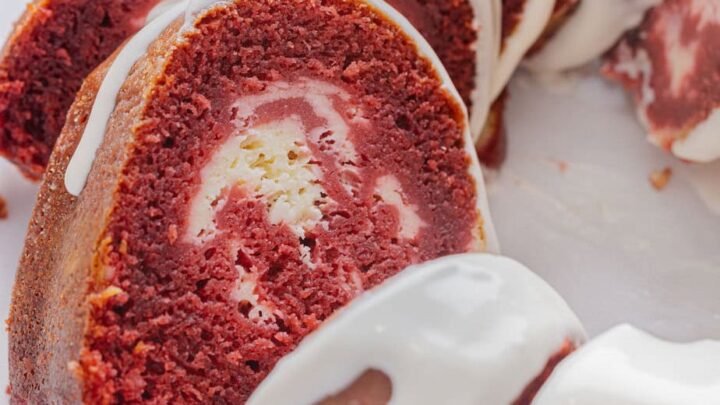 Red velvet cake with cream cheese filling on a plate.