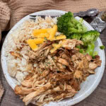 Crock Pot balsamic chicken on a plate with rice and broccoli.