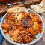 Lazy lasagna on a plate with some bread.