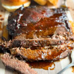 Sliced beef brisket on a cutting board.